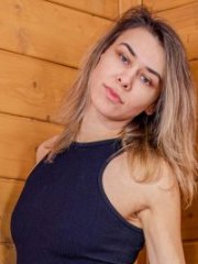 Tattooed MILF Anika Now slowly strips naked on the cabin stairs
