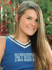 Naughty cheerleader Abby Rocks peels off her clothes outdoors in the garden
