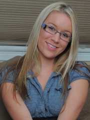 Blonde amateur Kristi Kay strips and spreads her pink pussy on the couch