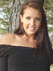 Busty brunette babe Lorette strips totally naked outdoors in the forest